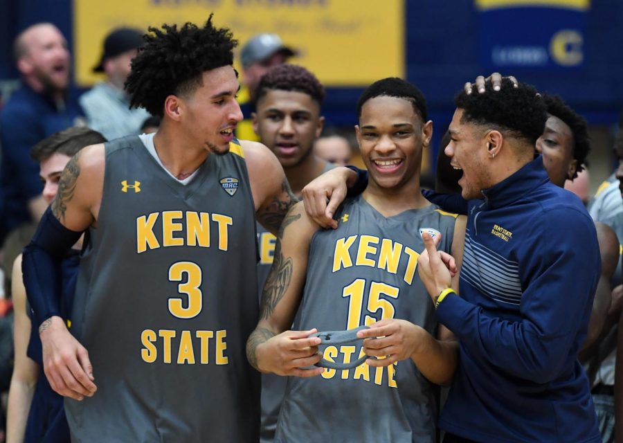 Kent States Anthony Roberts (15) celebrates with Akiean Frederick (3) and Troy Simmons after defeating Toledo 87-85 in overtime, Tuesday at the M.A.C. Center.