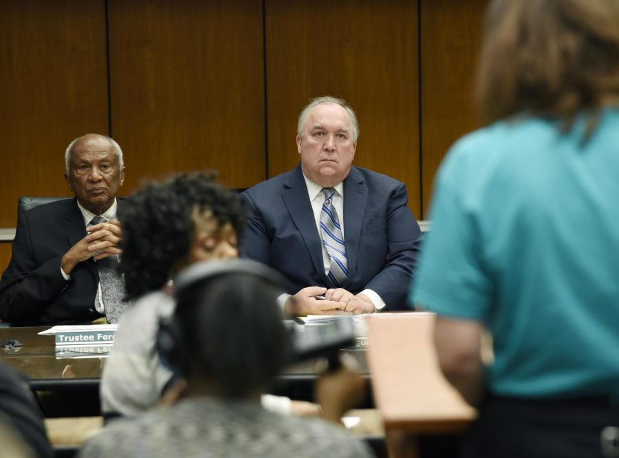 Interim President John Engler, center, and trustee Joel Ferguson listen to a student during the public comment portion of the Michigan State Board of Trustees meeting on Jan. 9, 2019, in East Lansing, Michigan. (Clarence Tabb Jr./Detroit News via AP)