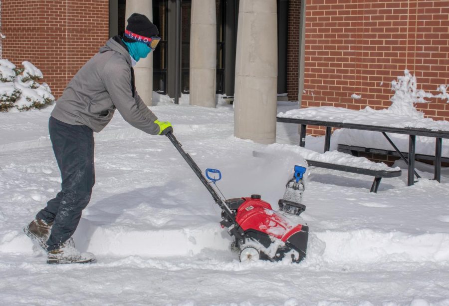 Matt Dansco, a grounds worker, removes snow outside of Stopher Hall on Jan. 22, 2019. 