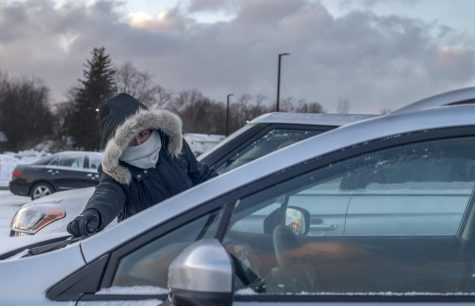 Elizabeth Chilton, a senior teaching English as a second language, clears snow off of her car on Tuesday, Jan. 29, 2019.