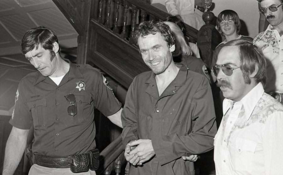 Serial killer Ted Bundy, center, is escorted out of court at the Pitkin County courthouse, Aspen, Colorado, in 1977. 