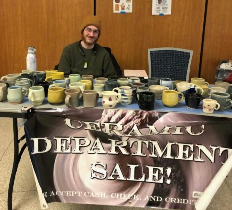 Graduate student Patrick Bell sells ceramic mugs in the Student Center on February 12, 2019.