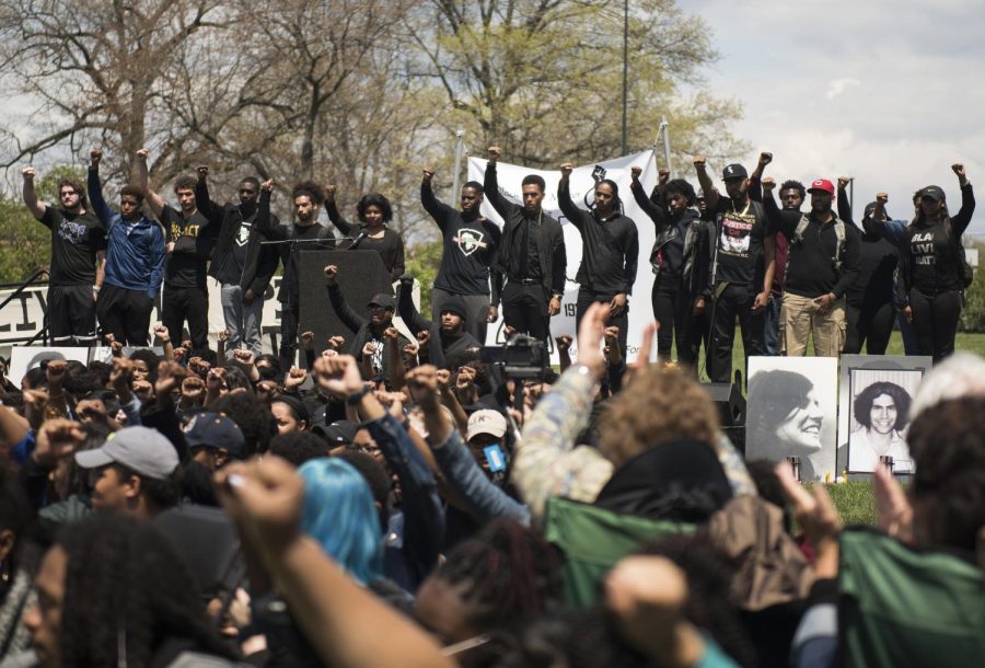 Kent State’s Black United Students raise their fists to symbolize black power during the ceremonies held in the Commons on Wednesday, May 4, 2016.