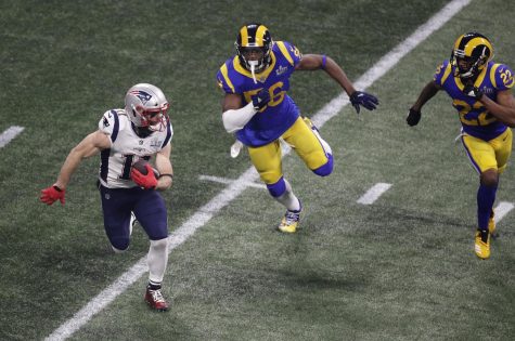 New England Patriots Julian Edelman (11) runs past Los Angeles Rams Dante Fowler (56) and Marcus Peters (22) during the second half of the NFL Super Bowl 53 football game Sunday, Feb. 3, 2019, in Atlanta. (AP Photo/Charlie Riedel)