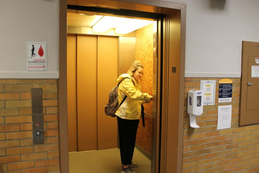 A student uses the elevator in McGilvrey Hall.