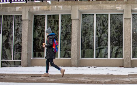A student walks by the May 4 Visitors Center Wednesday, March 6, 2019