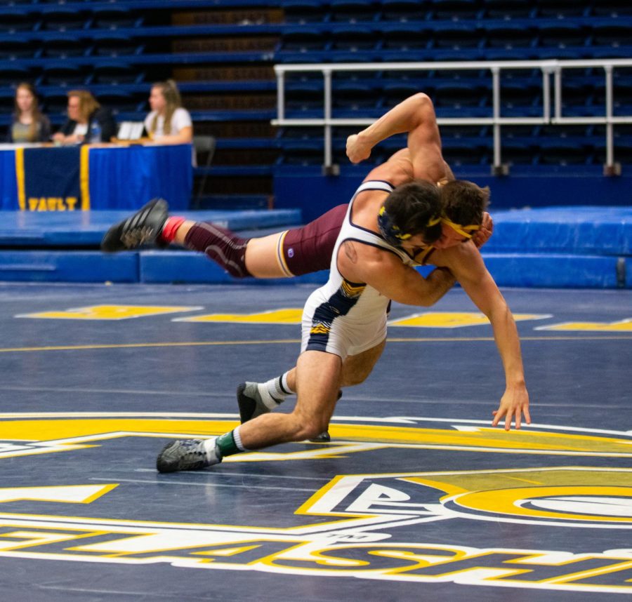 Junior Tim Rooney takes down a Central Michigan wrestler during the Beauty and the Beast match on February 10, 2019. The Flashes wrestlers lost 12-23.