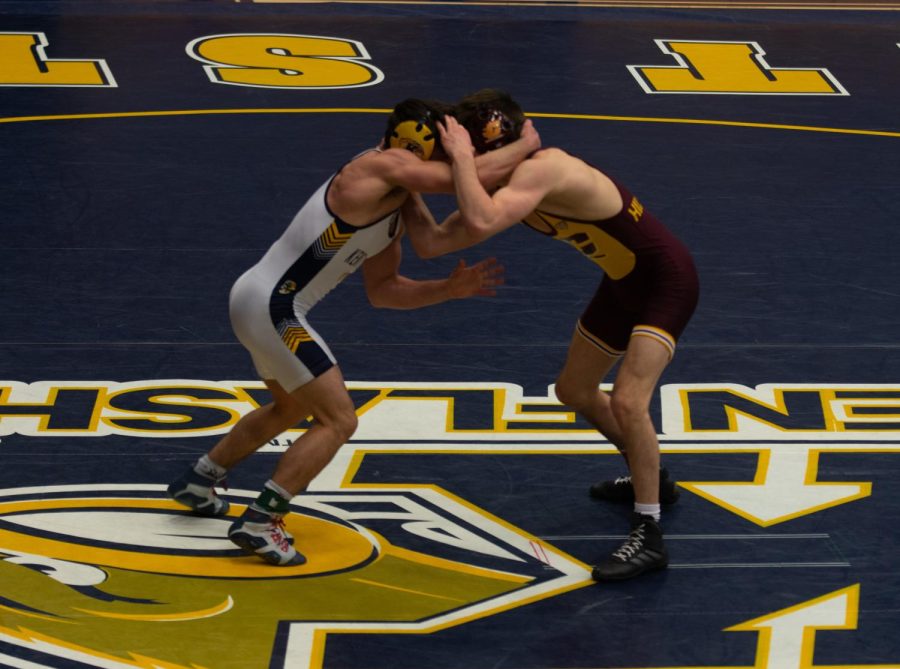 Junior Tim Rooney wrestles against Central Michigan at the Beauty and the Beast match on Sunday, Feb. 10, 2019.