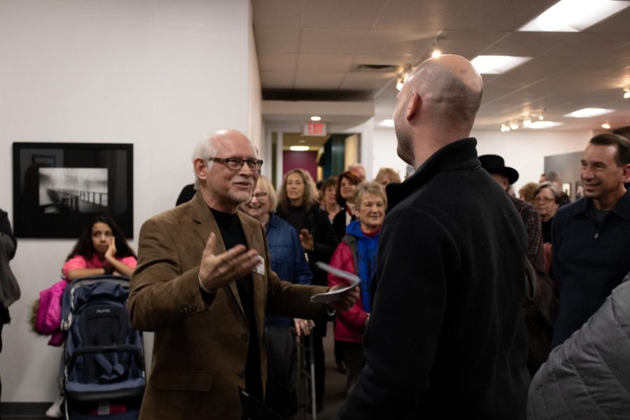 Kent State Journalism and Mass Communications professor Gary Harwood awards second place to Thomas Skala for his photo called Verticalibration. On Friday, March 1, 2019.