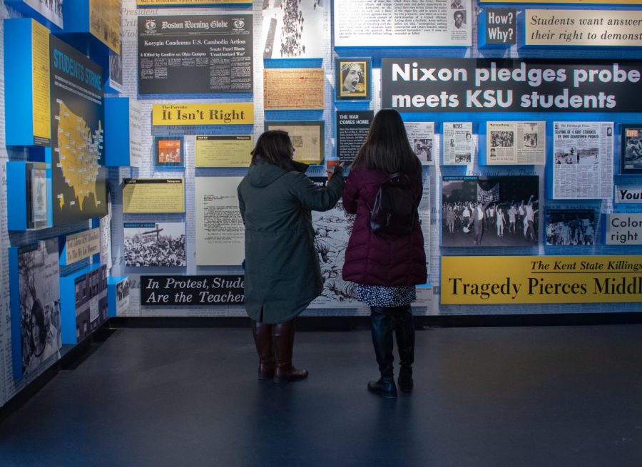 Two women observe the exhibit inside the May 4 Visitors Center Wednesday, March 6, 2019.