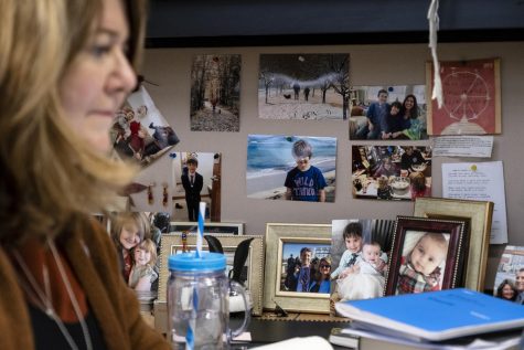 Schultz works at her desk in her Franklin Hall office, surrounded by pictures of her family, Wednesday, Feb. 27, 2019.