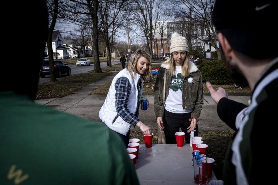 People play beer pong on a lawn outside a house on Summit St on March 16, 2019. 