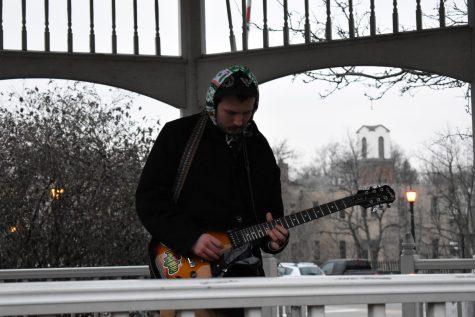 Dion Hetzel, of Ride the Vibe, plays music for patrons of the Mardi Crawl celebration in the gazebo on the corner of Franklin Ave. and W. Main Street on March 2, 2019.