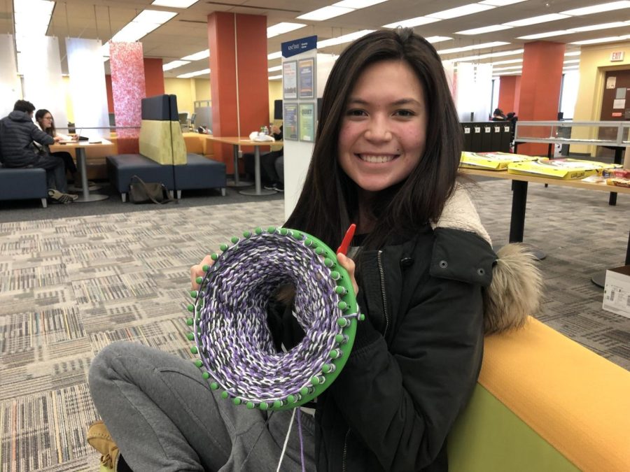 Alyssa+Bodnar+knitting+a+hat+on+a+loom+during+the+12-hour+Knit-A-Thon+in+the+library+Friday%2C+March+15.