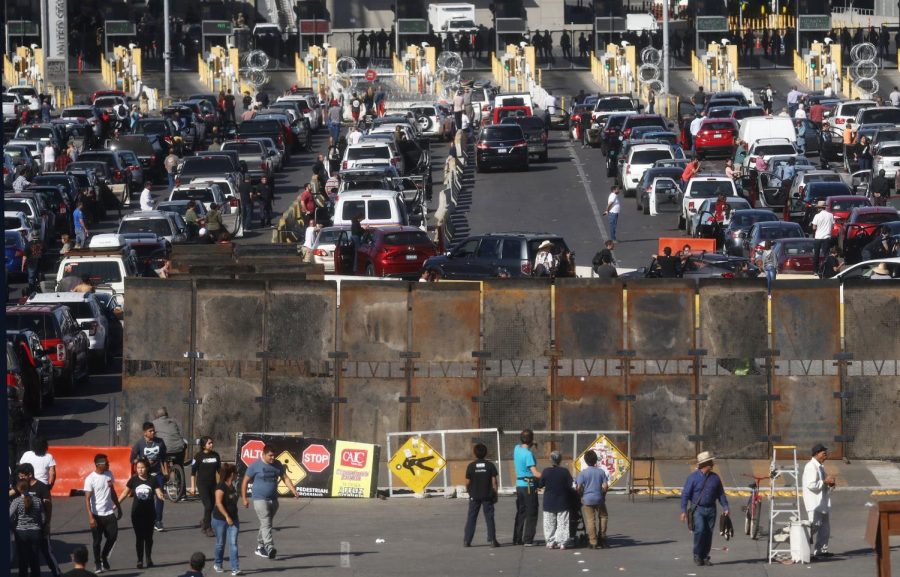 People attempting to cross in the US look on as the San Ysidro port of entry stands closed at the U.S.-Mexico border on November 25, 2018 in Tijuana, Mexico. 