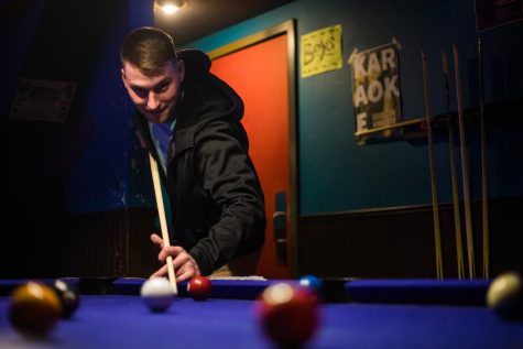 Scott Haines, 24, of Kent strikes the cue ball during a game of billiards at the Zephyr Pub in downtown Kent on Tuesday, April 16, 2019.