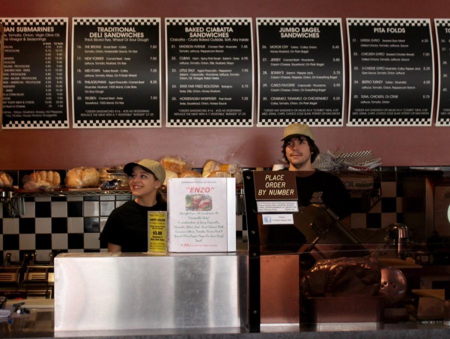 Franklin Square Deli employees Danielle Schwat and Adam Van Heyde wait behind the counter for customers on Friday, April 15, 2016.