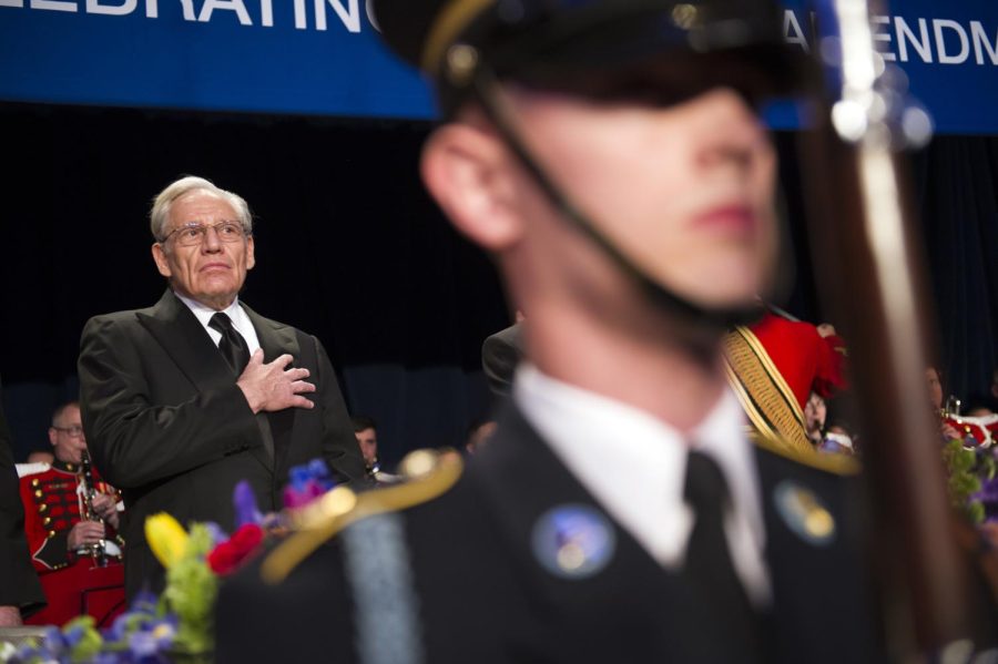 Journalist Bob Woodward places his hand over his heart as an honor guard performs the National Anthem during the White House Correspondents' Dinner in Washington, Saturday, April 29, 2017. (AP Photo/Cliff Owen)