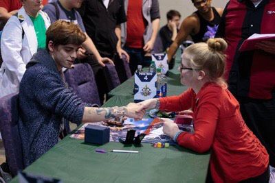 Natalie Shampay, a Kent State student and Pokemon player, shakes hands with former player Igor Costa before a match at the 2018 Charlotte, NC regional championship on March 18, 2018.