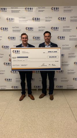 GreekDoor co-founders Nano Gorostiza (right) and Matthew King hold up their $15,000 check they received for taking first place in the CEBI Pitch competition. 