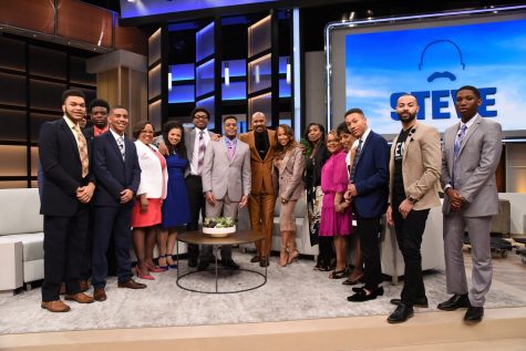Steve and Marjorie Harvey (middle) stand with the eight scholarship recipients and university staff members who accompanied them after the filming of his talk show Steve on May 9, 2019.
