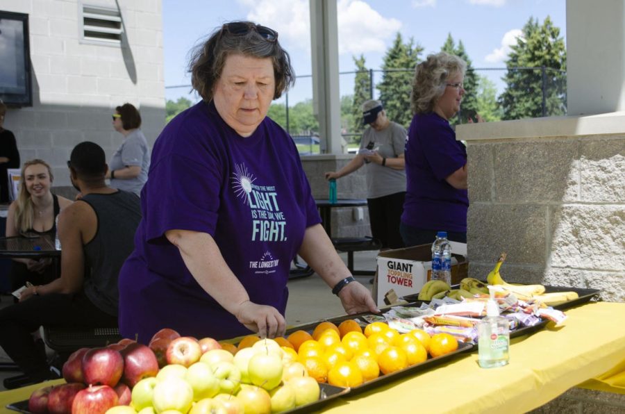 Sandra Cole, a special assistant at the Employee Wellness department, makes sure the snacks are well-stocked during The Longest Day event held at the Recreational Fields near Stewart Hall on June 21, 2019. 