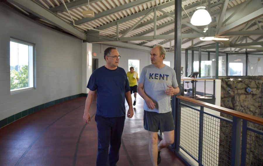 President Todd Diacon (right) walks next to Associate Dean for Administration Donald Williams (left) as they talk and exercise at the Student Recreation and Wellness Center on July 1, 2019.