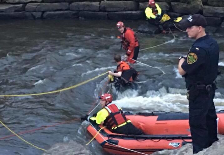 The Portage County Water Rescue Team attempts to lead Shawn Bachman back to shore using rope on July 6, 2019. 