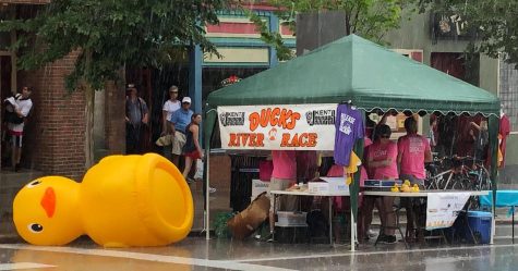 The inflatable duck at the Junior Chamber of Commerce booth is knocked down by the strong wind and rain at the Heritage Festival on July 6, 2019.