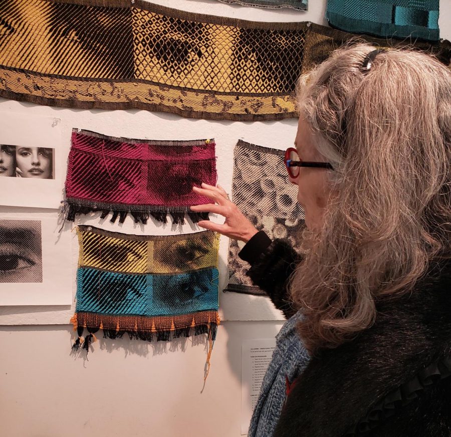 Janice Lessman-Moss, professor of textiles in the School of Art, looks at students' work. 