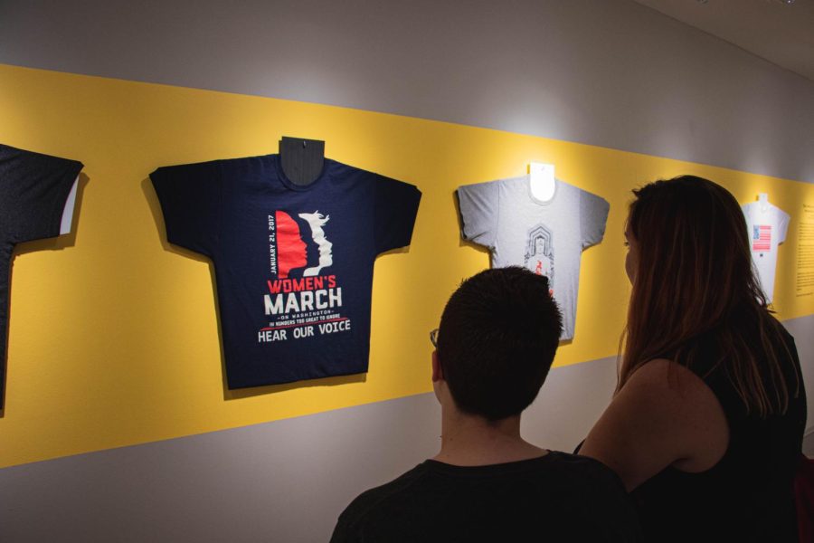 Moira Armstrong an English and History major(Left) and Jordan George a Fashion major (Right) admire the Wearing Justice exhibit at the Kent State University Museum. This Exhibit shows the use of Graphic T-Shirts during heated political moments and showcases their meanings. Sep 13, 2019.