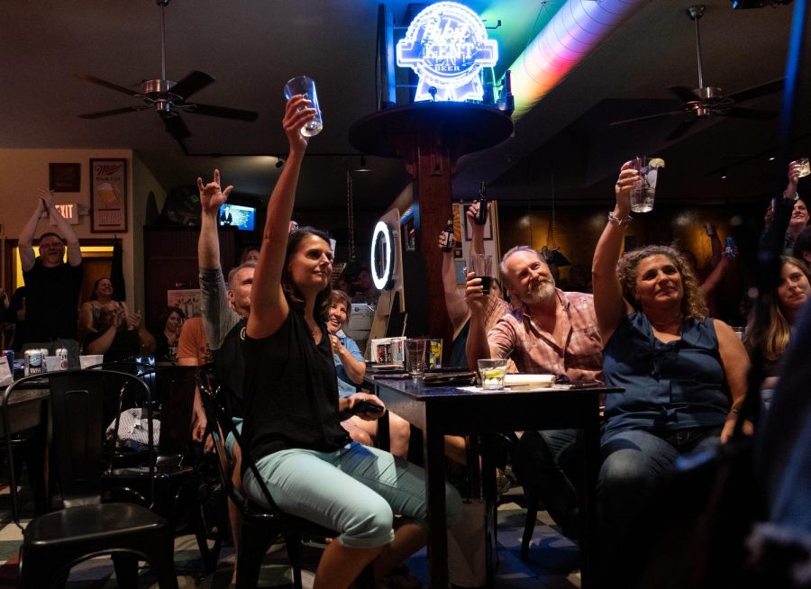 Venice Cafe patrons raise their glasses while Roger Hoover and the Whiskeyhounds perform their final song at Venice Cafe during Kent's Round Town music festival on Friday, September 13, 2019.