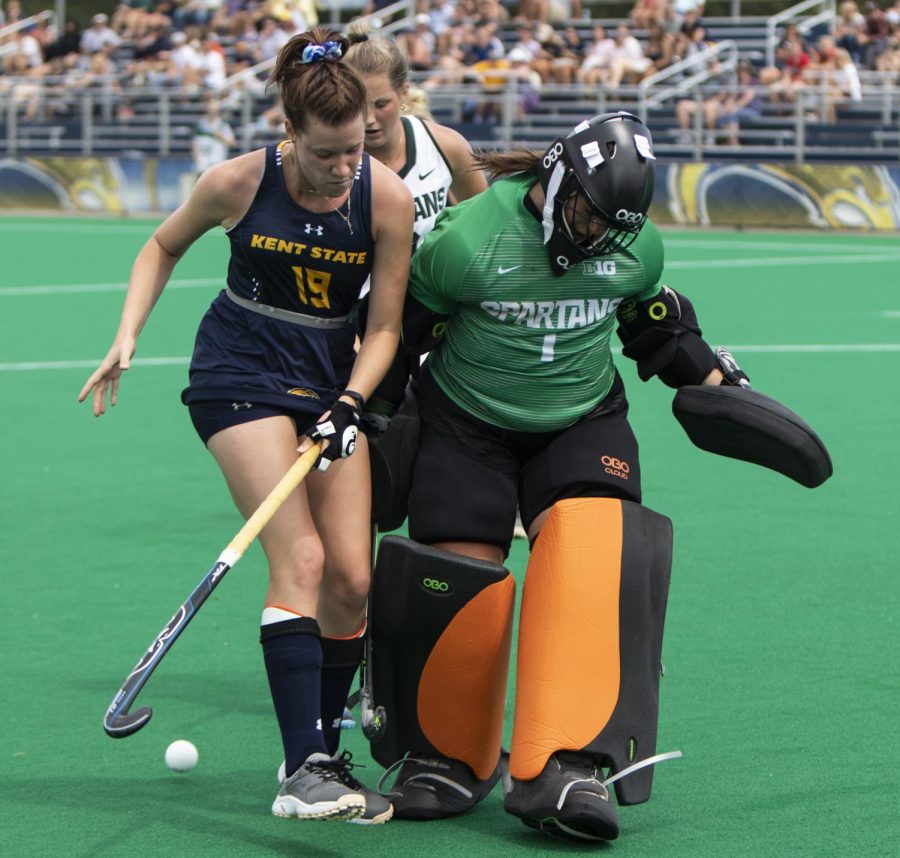 Sophomore forward Luisa Knapp collides with Michigan State goalkeeper Jade Arundell during an unsuccessful penalty corner. The Golden Flashes lost 0-1 to Michigan State University Sunday. 