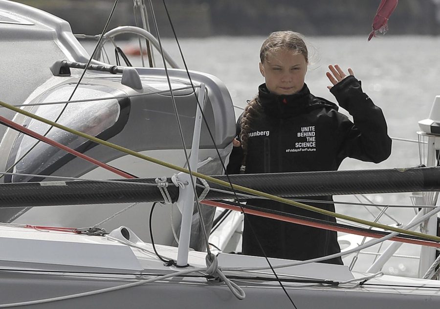 Climate change activist Greta Thunberg waves from the Malizia II boat in Plymouth, England, Wednesday, Aug. 14, 2019. The 16-year-old climate change activist who has inspired student protests around the world will leave Plymouth, England, bound for New York in a high-tech but low-comfort sailboat.(AP Photo/Kirsty Wigglesworth, pool)