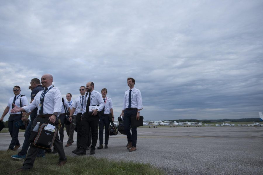 Pilots return to their friends and family after an air show at the Kent State FedEx Aeronautics Academic Center grand opening on Sept. 6, 2019. 