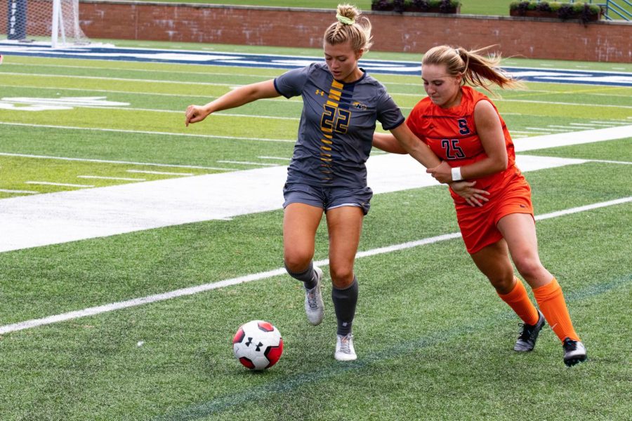 Kent State Womens Soccer player Cameron Shedenhelm (#22) Blocks a player of the opposing team from getting access to the ball. In this game, Kent State v Syracuse, Kent won 1-0. Dix Stadium, Sep 8, 2019.