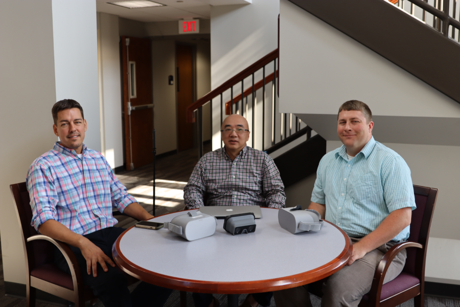 Professors Rick Ferdig, Cheng Chang Lu and Karl Kosko sit behind some of the technology that supports their project.