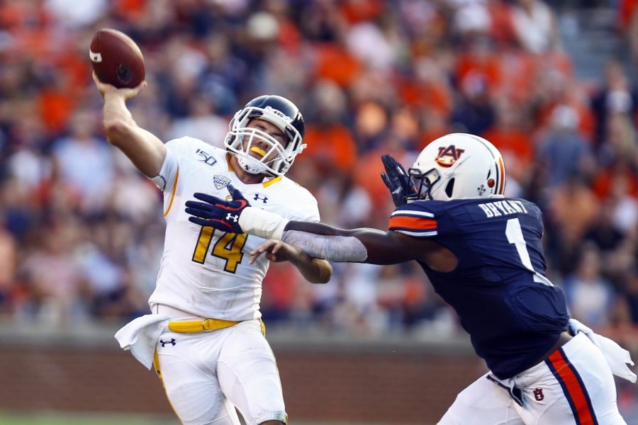 Kent State quarterback Dustin Crum (14) is hit by Auburn defensive end Big Kat Bryant (1) as he throws the ball during the first half of an NCAA college football game Saturday, Sept. 14, 2019, in Auburn, Ala. (AP Photo/Butch Dill)