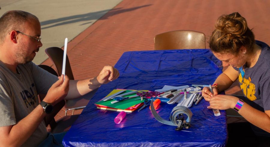 Cory Nagel and Madeline Reich start off the Flash Bash festivities by coloring slap bracelets. Madeline Reich works for the Flash Activities Board and handed out tickets to participants in the Flash Bash activities. Sept. 16, 2019.