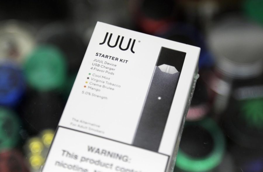 FILE+-+This+Dec.+20%2C+2018%2C+file+photo+shows+a+Juul+electronic+cigarette+starter+kit+at+a+smoke+shop+in+New+York.+Juul+is+the+largest+U.S.+seller+of+electronic+cigarettes%2C+controlling+about+70+percent+of+the+market.+The+San+Francisco-based+company+rose+to+the+top+through+viral+marketing+that+promoted+high-nicotine+pods+with+dessert+and+fruit+flavors.+%28AP+Photo%2FSeth+Wenig%29