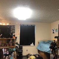 Marks residence hall room that she decorated with posters in Centennial Court F. 