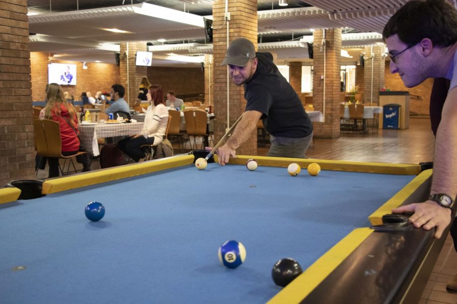 Jordan Yoerger plays pool with friends at the Patio in the Kent Student Center Oct 14, 2019.