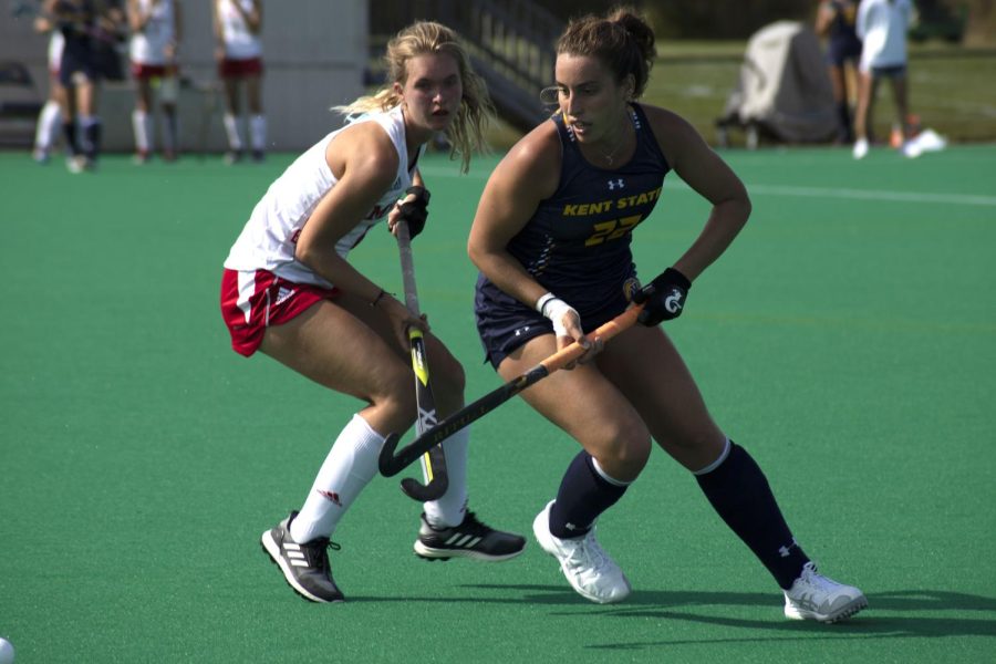 Helena Cambra Soler (right) turns to get the ball during the field hockey game on Oct. 11, 2019. The Golden Flashes played Miami University and won 3-2.
