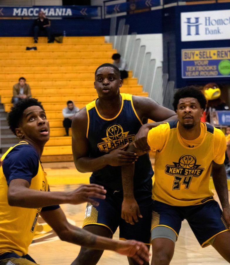 Kalin Bennett (center) is blocked by 2 players from the gold team during a Scrimmage on Nov 2, 2019.