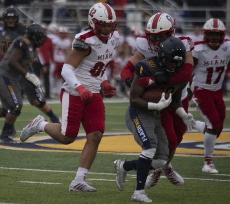 Redshirt sophomore running back Xavier Williams gets run down by Miami defenders during first half on Oct. 26, 2019. The Golden Flashes lost 16-23 against Miami Ohio.