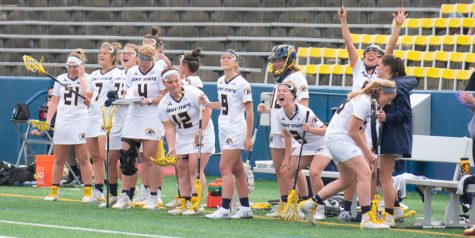 Members of the Kent State womens lacrosse team cheer after scoring a goal against Kennesaw State on April 11, 2019. Kent lost 11-18.