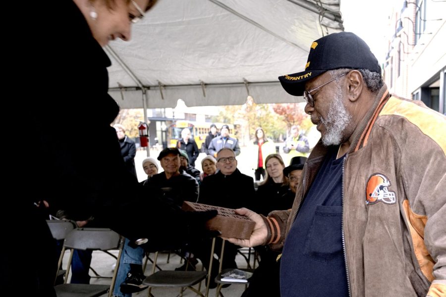 Claudia Amrhein, PARTA General Manager, presents veteran Walter Williams a brick inscribed with his name and time served during Kents Veterans Day Ceremony in downtown Kent on Monday, Nov. 11, 2019. Williams served continuously from 1975-1986 in the United States, Korea and Germany.