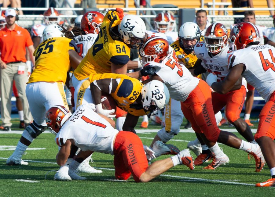 Bowling Green defenders stop Kent State's running back Jo-el Shaw during Homecoming game on Saturday, Sept. 21, 2019.