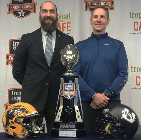 Kent State coach Sean Lewis (left) and Utah State coach Gary Andersen (right) pose for a photo with the Tropical Smoothie Cafe Frisco Bowl trophy after their joint press conference Thursday morning. Kent State will play Utah State in the Frisco Bowl tomorrow at 7:30 p.m. on ESPN2.
