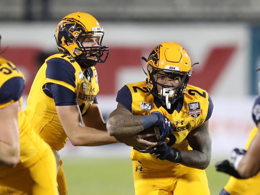 Kent State quarterback Dustin Crum (14) hands off to running back Will Matthews (2). Crum finished with a career-high 147 rushing yards, while Matthews added 56 yards and a touchdown.